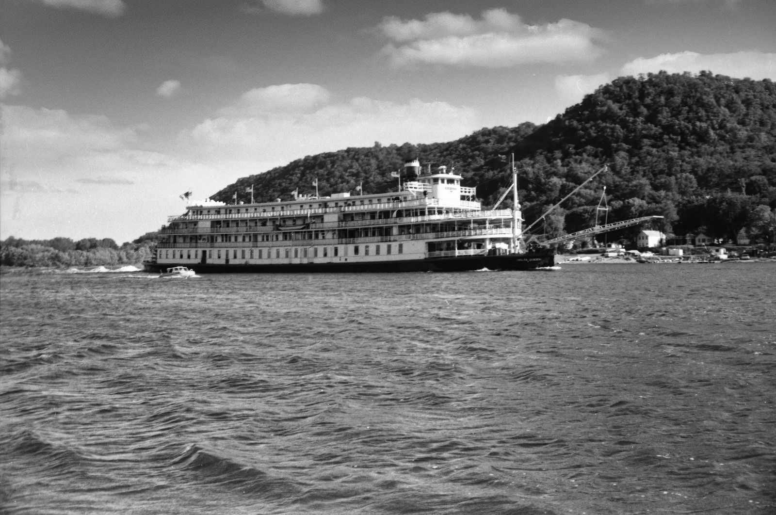 Grayscale image of a classic steamboat cruising the Mississippi River